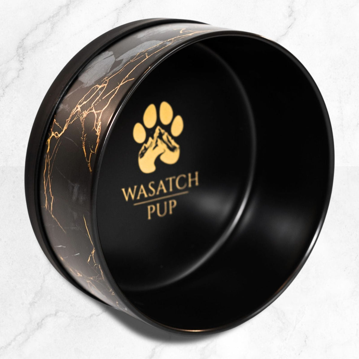 Black ceramic pet bowl with gold marble pattern and Wasatch Pup logo on interior