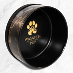 Black ceramic pet bowl with gold marble pattern and Wasatch Pup logo on interior