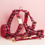 Red plaid dog harness with layered straps and gold buckles, matching leash hardware