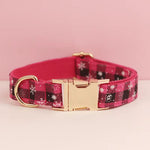 Red plaid dog collar with star motifs, gold buckle, and D-ring hardware