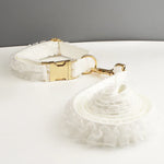 White ruffled dog collar with gold-tone buckle and leash attachment clip