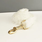 White ruffled dog leash with gold-tone snap and clip hardware