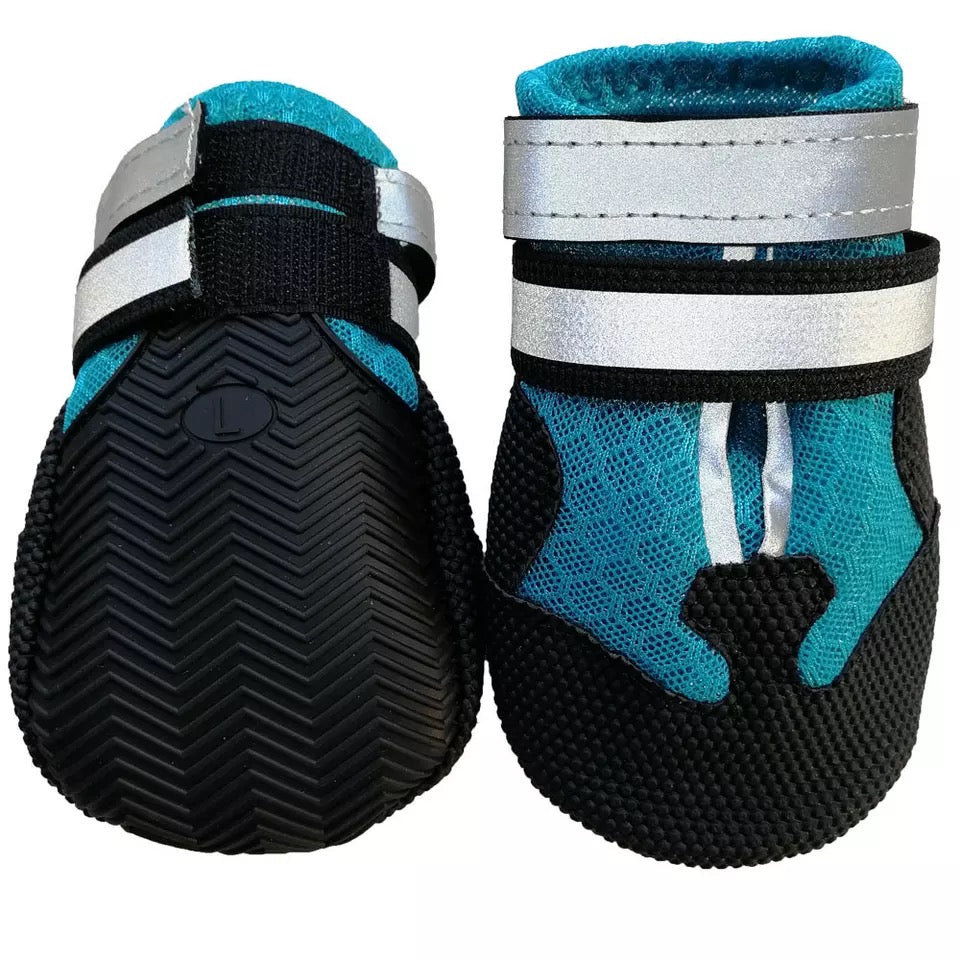 Pair of blue dog shoe covers with black rubber soles and paw pad cutout design