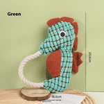 Green seahorse plush dog toy with rope handle and textured scale pattern