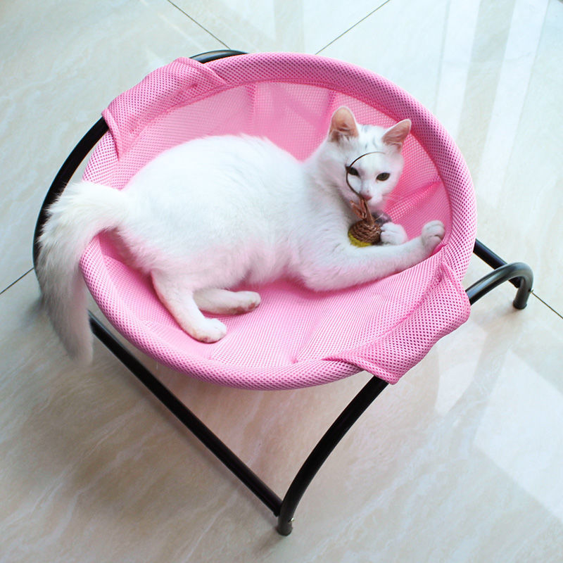 Pink breathable pet hammock bed with black frame, white cat sleeping inside