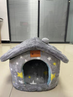 Gray plush pet house bed with star pattern and round dark doorway entrance