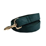 Dark green corduroy dog collar detail with gold-tone clip and D-ring