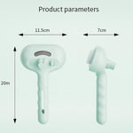 Pet steam brush in mint-green with oval textured cleaning head and grip handle