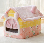 Pink and yellow enclosed pet house bed with plush hood-style door and roof blanket