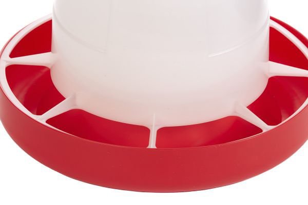 Red circular feeder base with inner feed ports for poultry