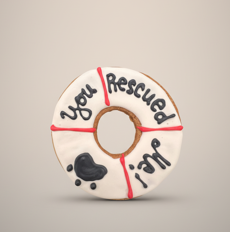 Rescue-themed cookie toy donut with black paw and dog drawings, red details