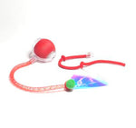 Red interactive cat rolling ball toy with glowing light, connected to long string