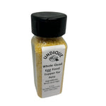 Quail egg food topper bottle with black cap and front label on white