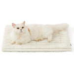 White faux rabbit fur pet mat with quilted ribbed surface, with a cream cat resting.