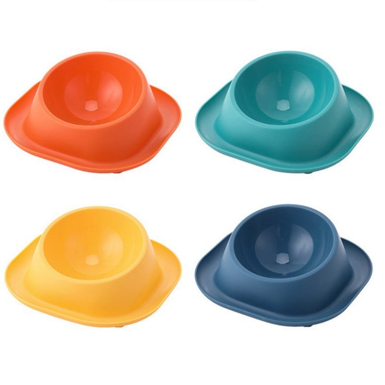 Tilted cat food bowls with four colored bases: orange, teal, yellow, dark blue