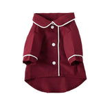 Small wine-red pet dog jacket with white trim, snap buttons, and two side pockets