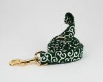 Green swirl dog leash with gold trigger clip and matching patterned fabric