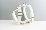 White leather dog harness with gold buckles and removable bowtie