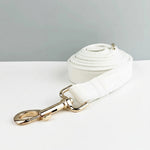White leather dog leash with gold swivel clip and rolled strap