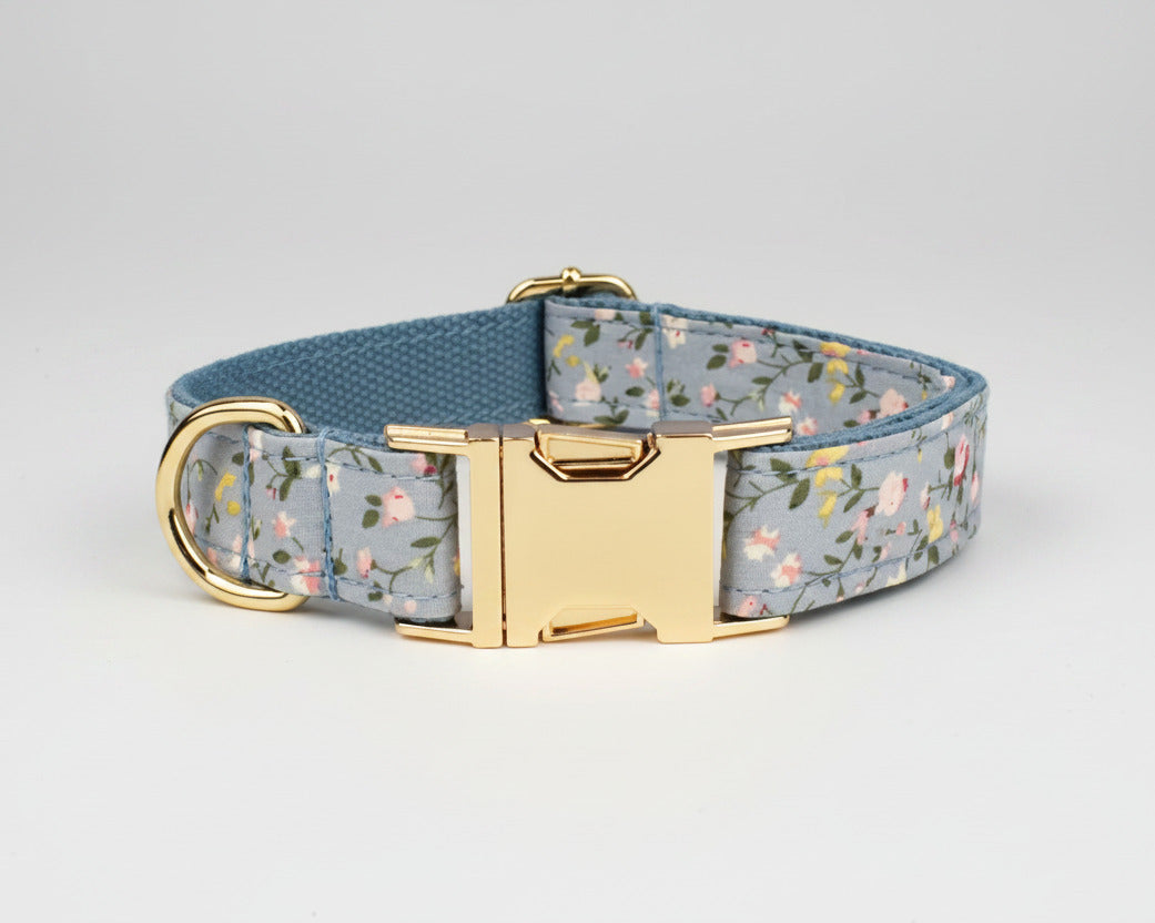 Dusty blue floral dog collar close-up with gold buckle and engraved plate