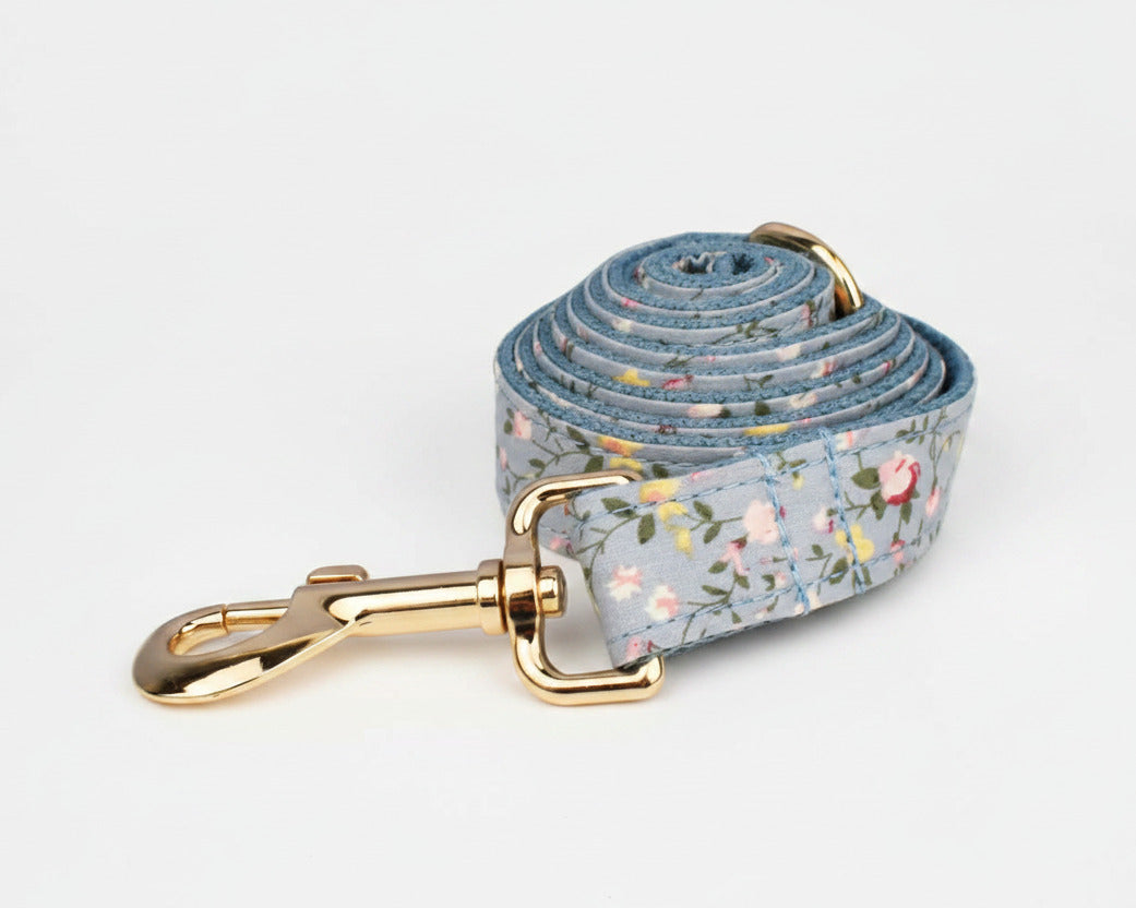 Dusty blue floral dog leash with gold clasp and coiled strap