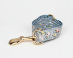 Dusty blue floral dog leash with gold clasp and coiled strap