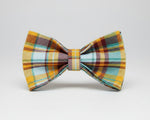 Plaid bow tie with teal, orange, and mustard check pattern