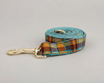 Plaid dog leash in teal and orange with gold-tone clasp