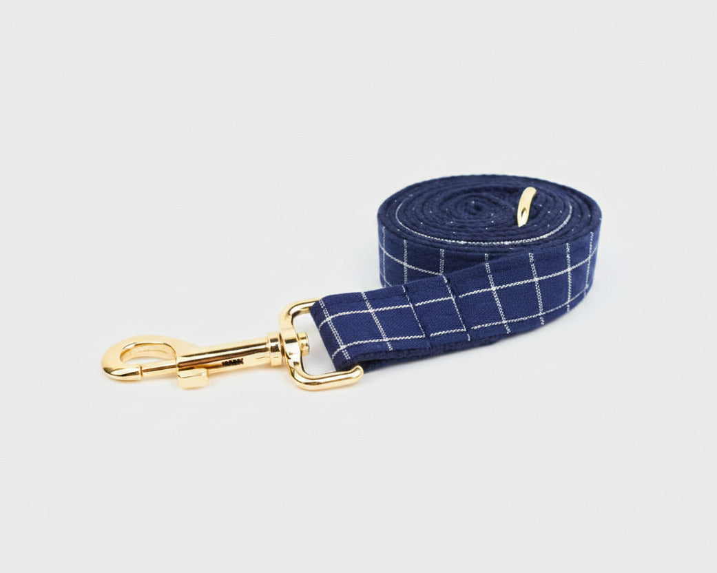 Dark blue plaid leash roll with gold swivel clip