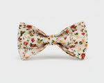 Floral dog bowtie with ivory base and small blossom print, center clip attachment