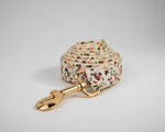 Ivory floral dog leash with gold metal clasp and stitched fabric handle