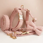Pink teddy plush dog harness, bowtie, and collar with gold hardware and “COCO” tag