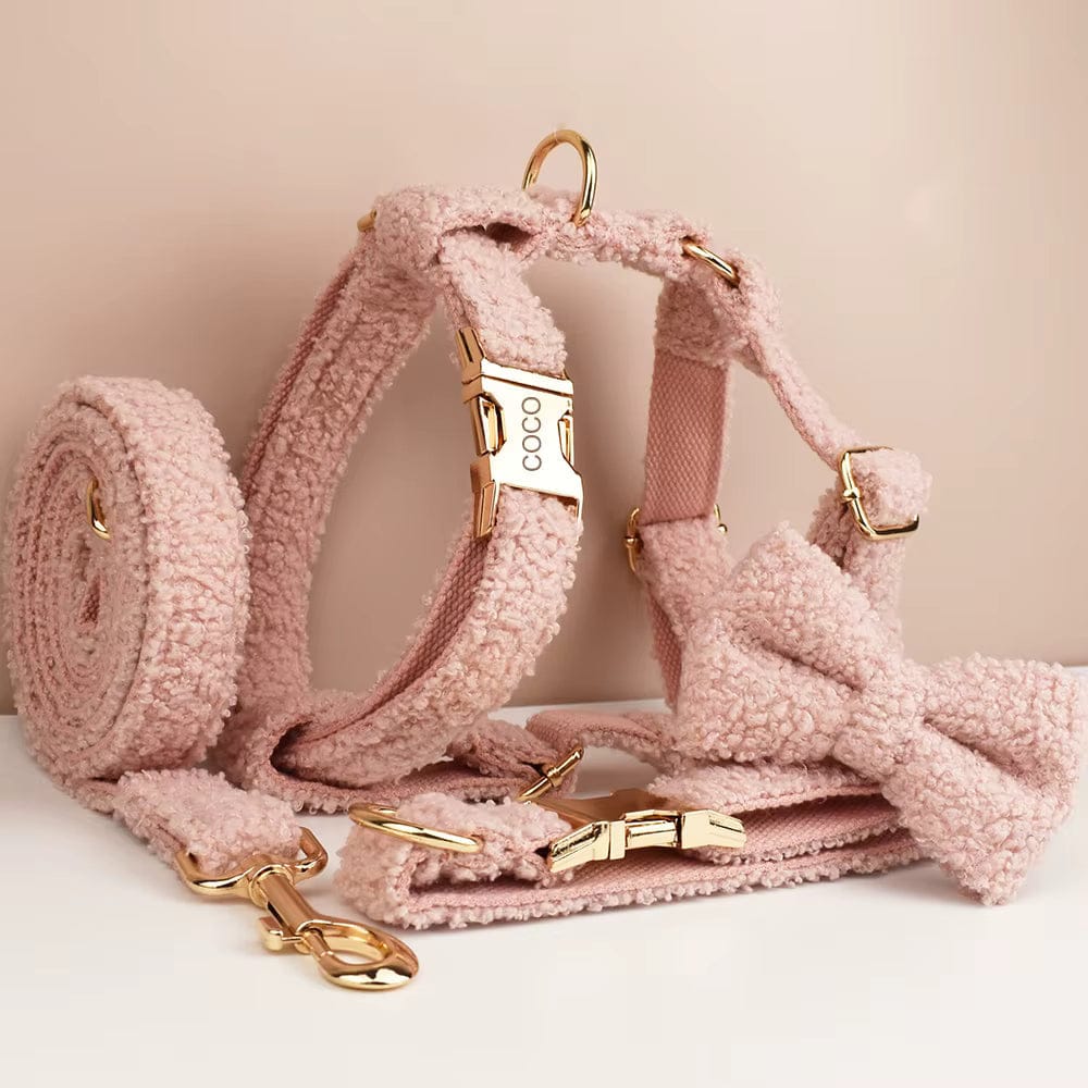 Pink teddy plush dog harness, bowtie, and collar with gold hardware and “COCO” tag