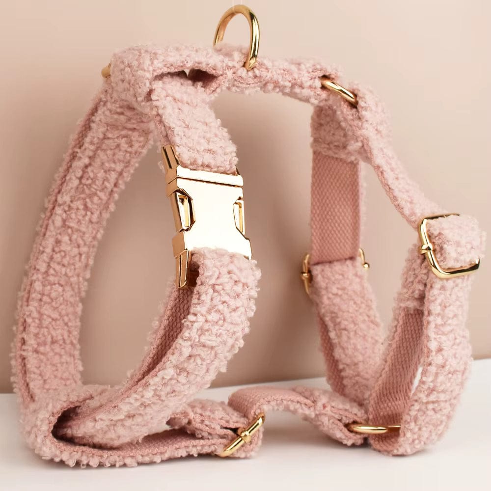Pink teddy plush dog harness with gold hardware and front clasp, straps shown