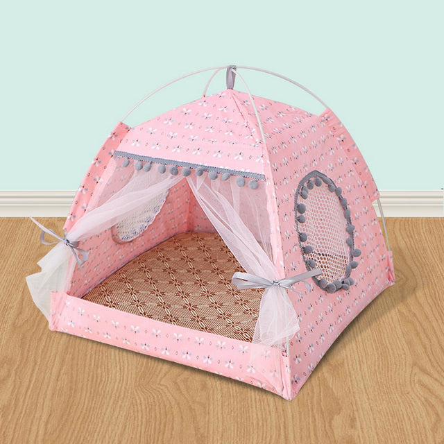 Pink pet tent bed with open mesh curtains, curved frame, and textured fabric floor