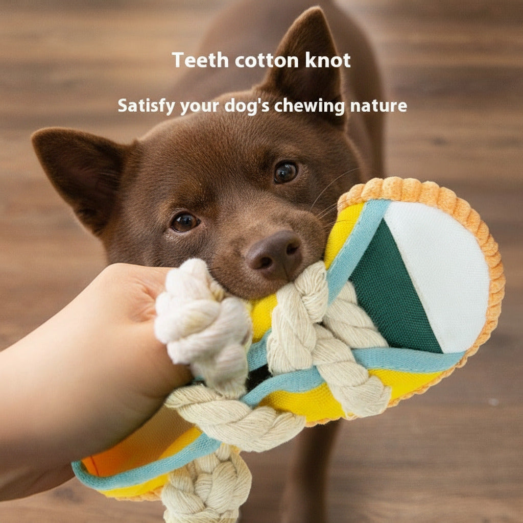 Squeaky plush shoe dog toy with yellow body, green stripe, blue handle, and knot laces