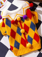 Multicolor zigzag knitted pet sweater with pom-pom accents and ribbed edges