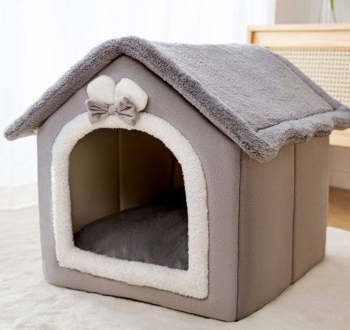 Gray enclosed pet house bed with cushioned arched door and folded roof blanket