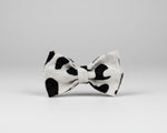 Heart-print bow tie: white fabric with black hearts, centered bow