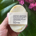 Pet soap bar back label with ingredients text, held in hand