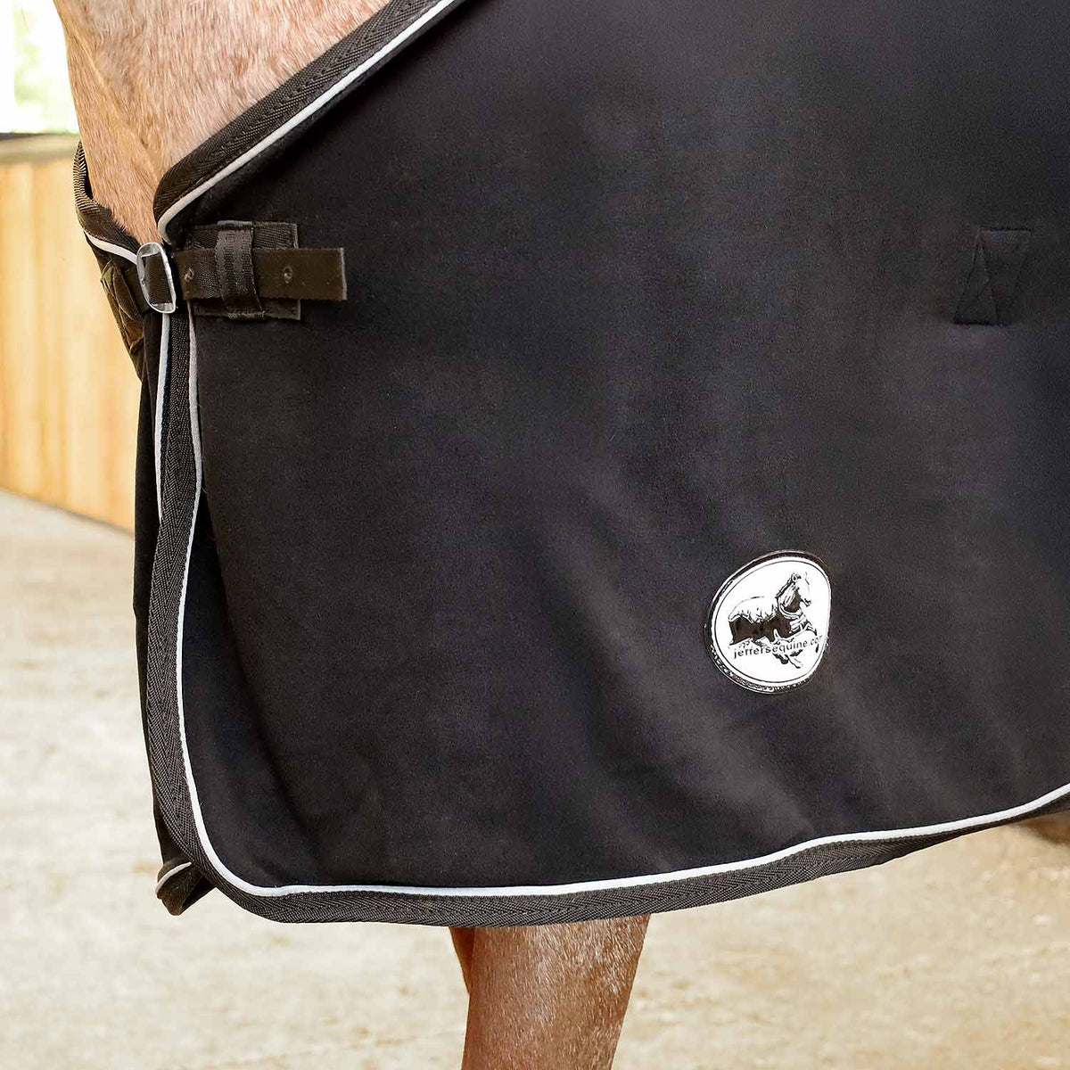 Horse fleece cooler blanket, black side view with round logo patch and white trim