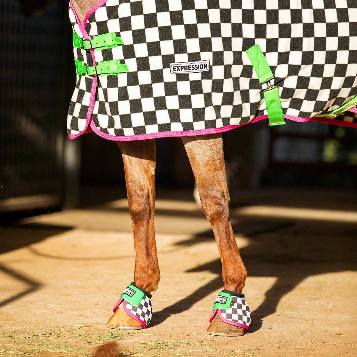 Horse cooler fleece with black-and-white check print, neon green and pink trim