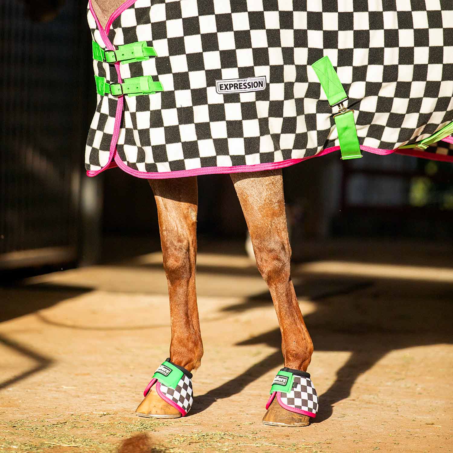 Horse cooler fleece with black-and-white check print, neon green and pink trim