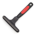 Pet undercoat grooming rake with spring metal pins and black handle with red textured grip