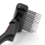 Pet grooming undercoat rake head with spring metal pins and black handle close-up