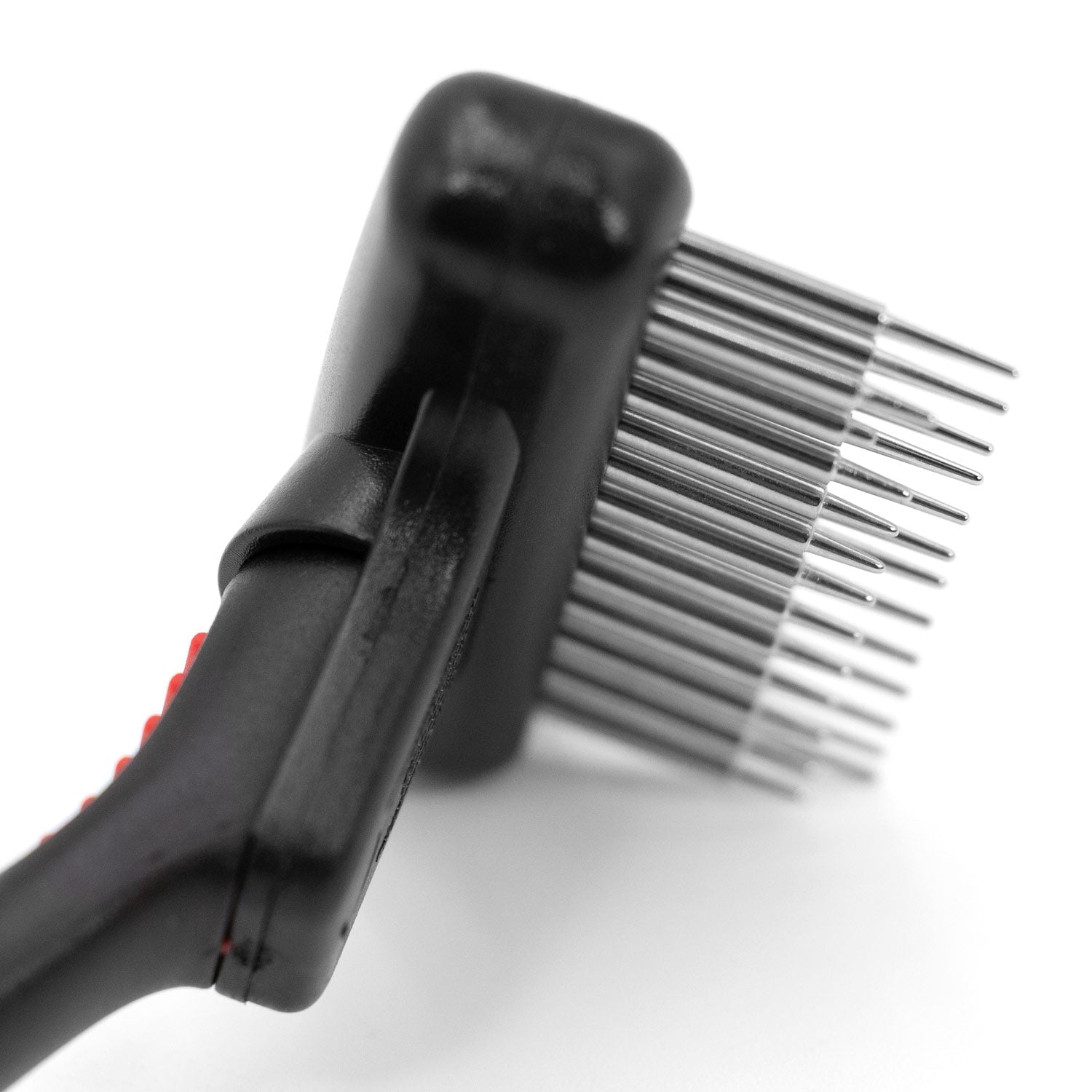 Pet grooming undercoat rake head with spring metal pins and black handle close-up