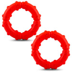 Two red rubber dog tug ring chews with pawprint textured grips