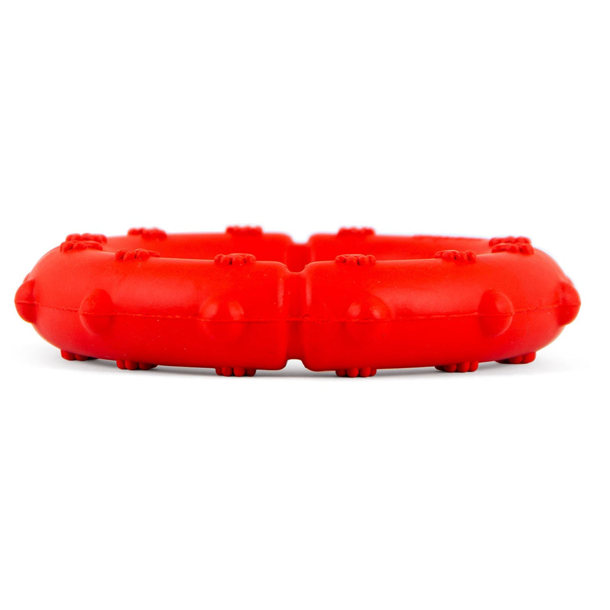 Red rubber dog tug ring chew with bumpy pawprint texture along top