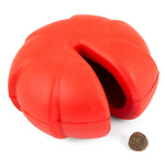Red natural rubber dental dog chew toy with open treat cavity and kibble