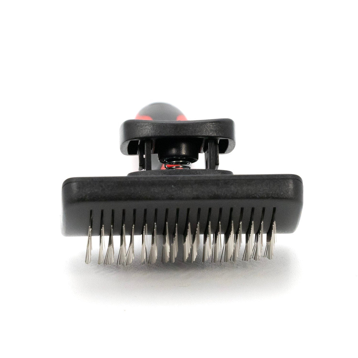 Self-cleaning slicker brush head with metal pins under a black housing
